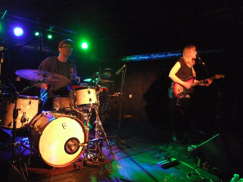 Band playing on the club's small stage under colored lights