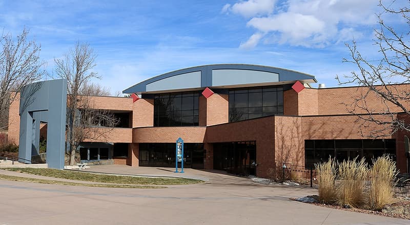 Brick front of the Arvada Center with its arched roofline