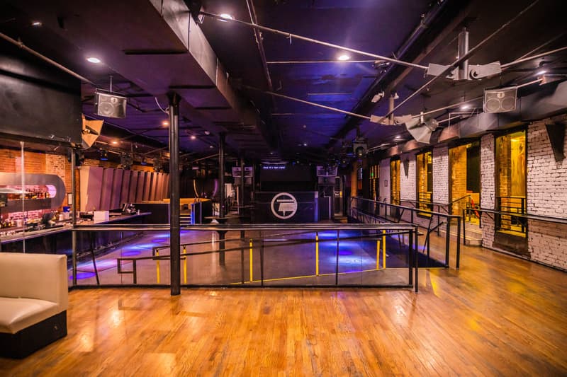 Empty Club Vinyl main floor and raised stage area under club lighting